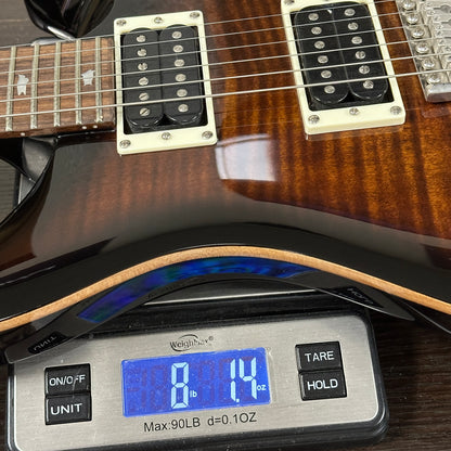 Guitar on a digital scale displaying weight