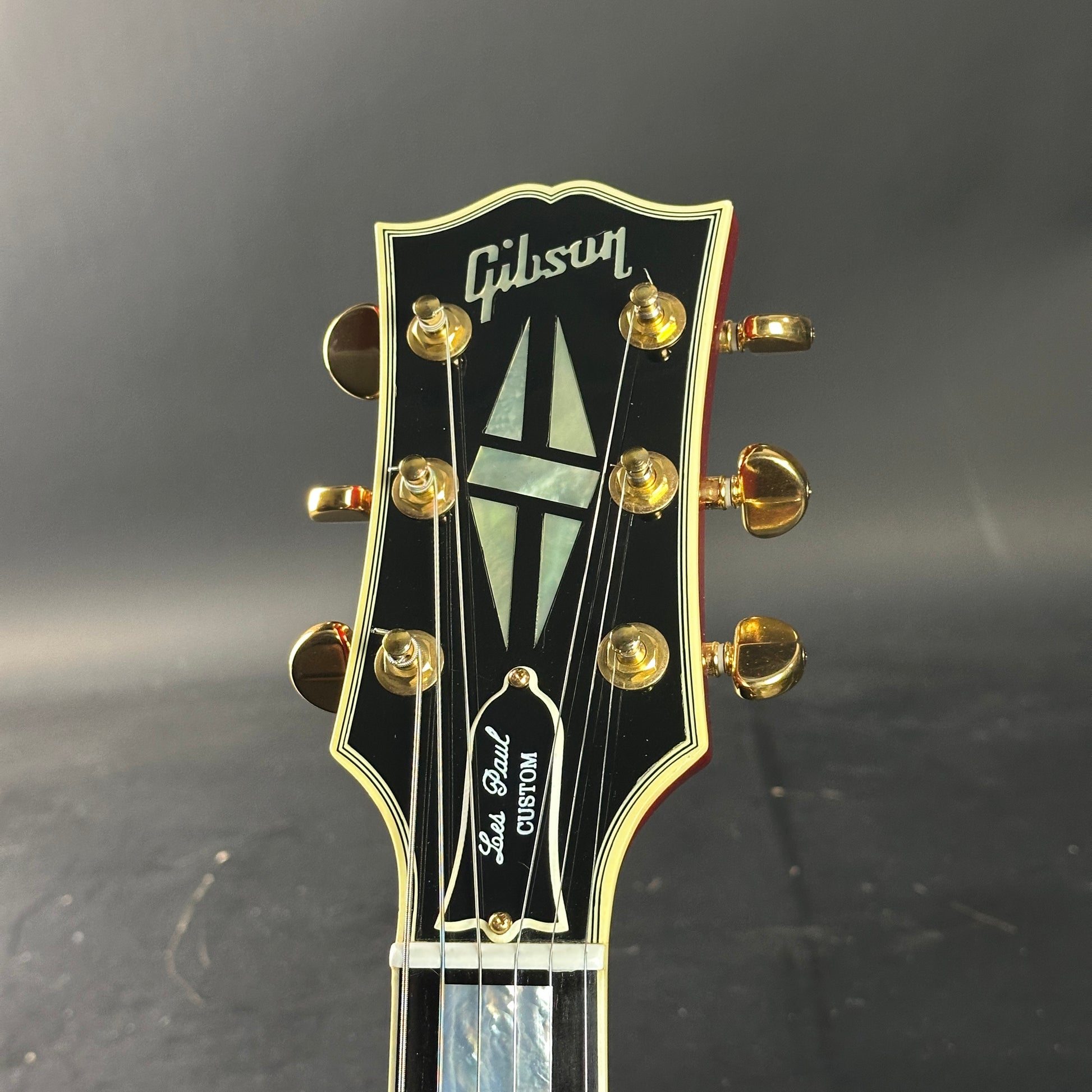 Gibson guitar headstock on a dark background