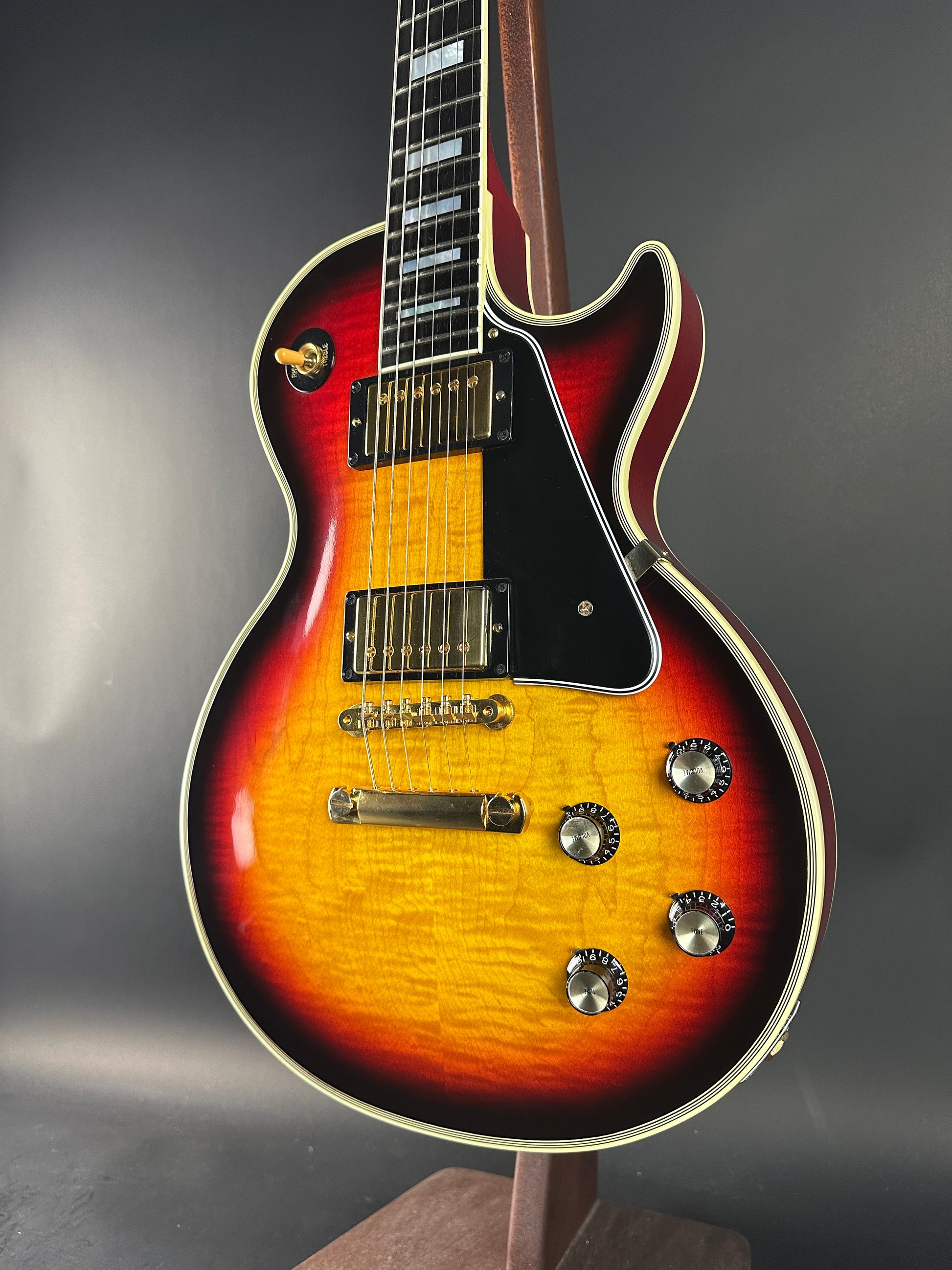 Electric guitar with a sunburst finish on a dark background