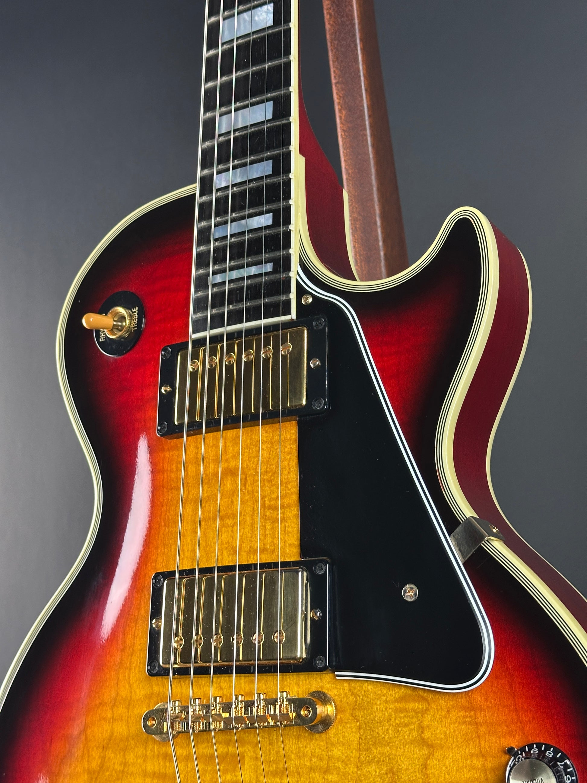 Electric guitar with a sunburst finish on a dark background