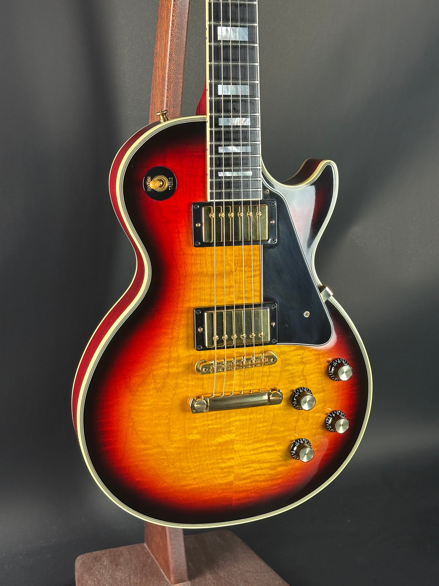 Electric guitar with a sunburst finish on a dark background