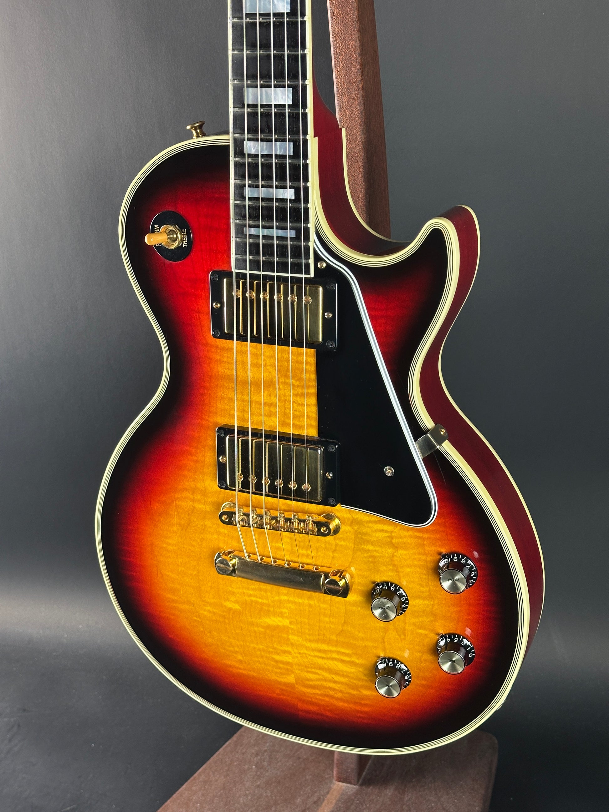 Electric guitar with a sunburst finish on a dark background