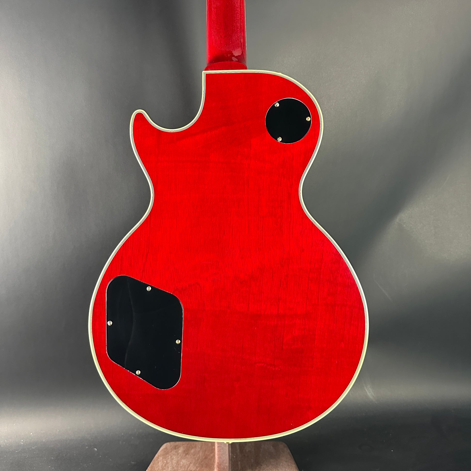 Red electric guitar on a gray background