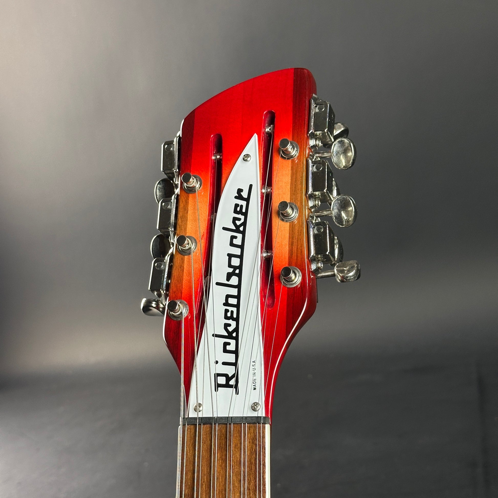 Guitar headstock with Rickenbacker logo on a gray background