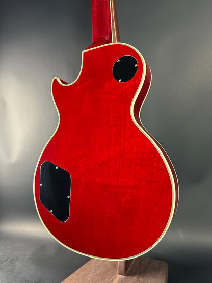 Red electric guitar body on a gray background