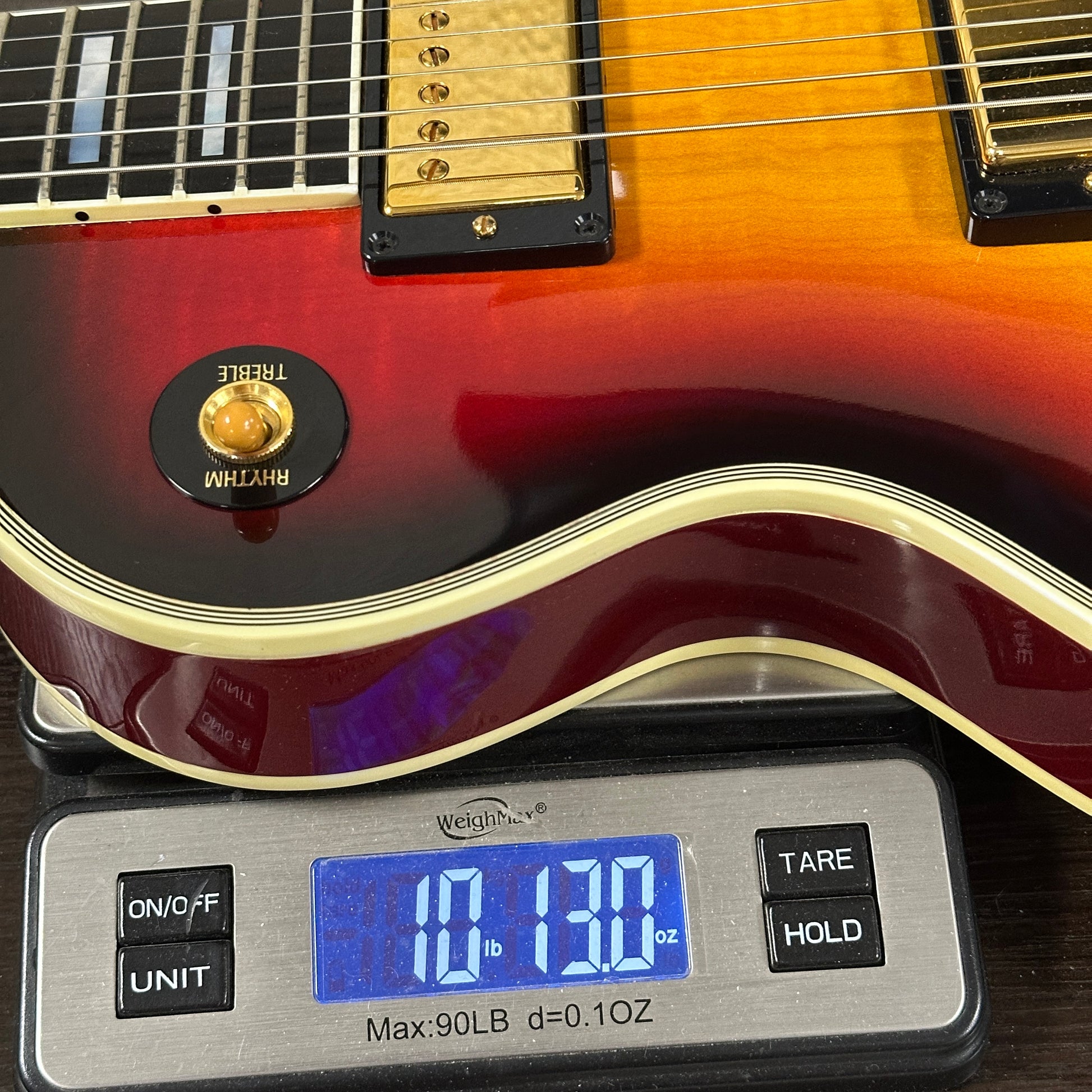 Electric guitar on a digital scale displaying weight