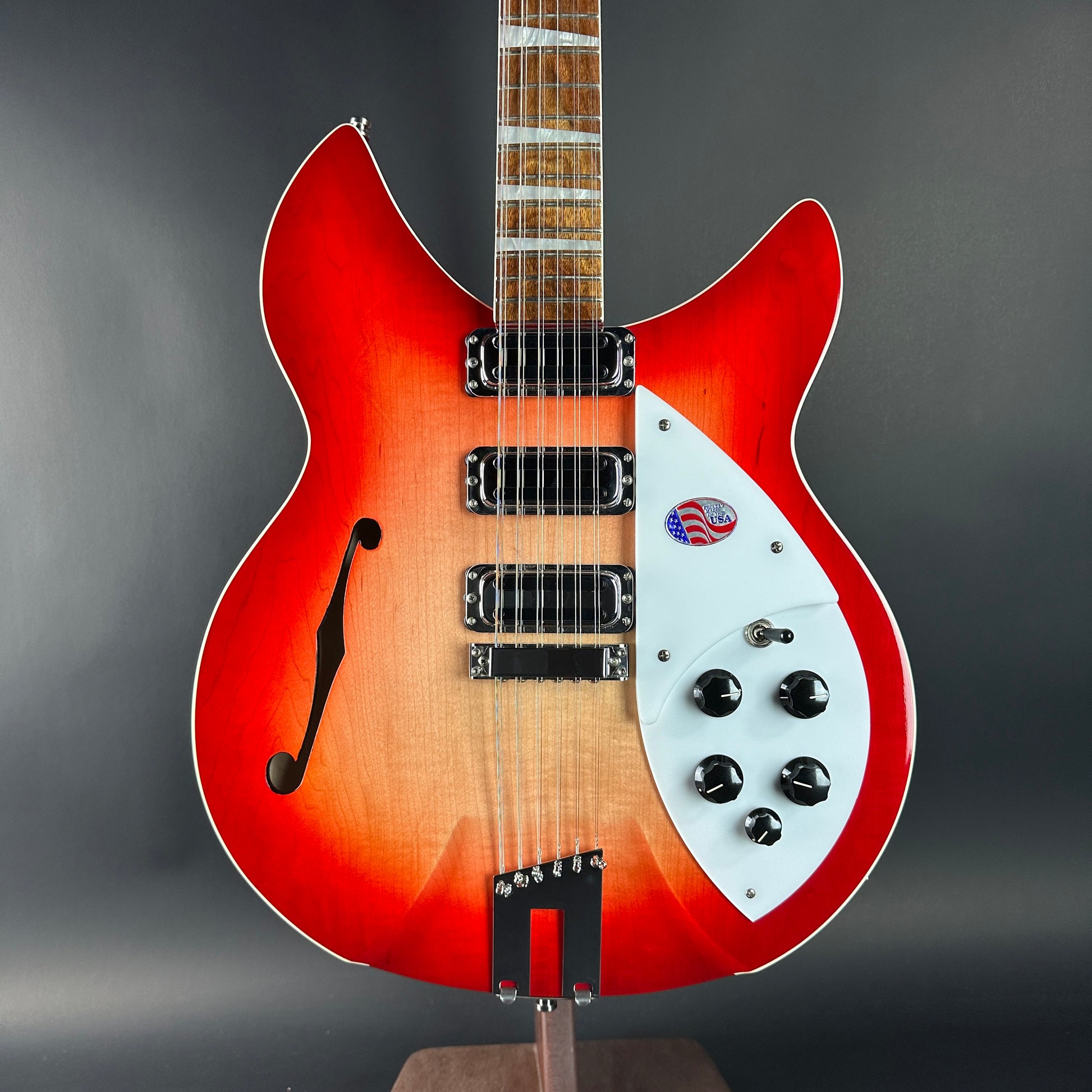 Electric guitar with a red and white design on a gray background