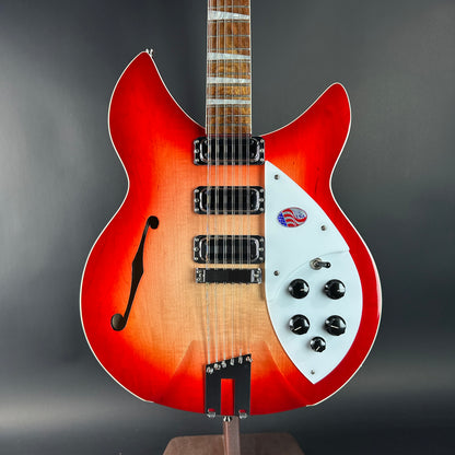 Electric guitar with a red and white design on a gray background