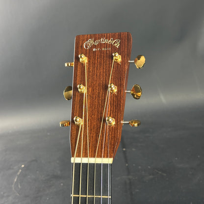 Guitar headstock with 'Martin' logo on a dark background