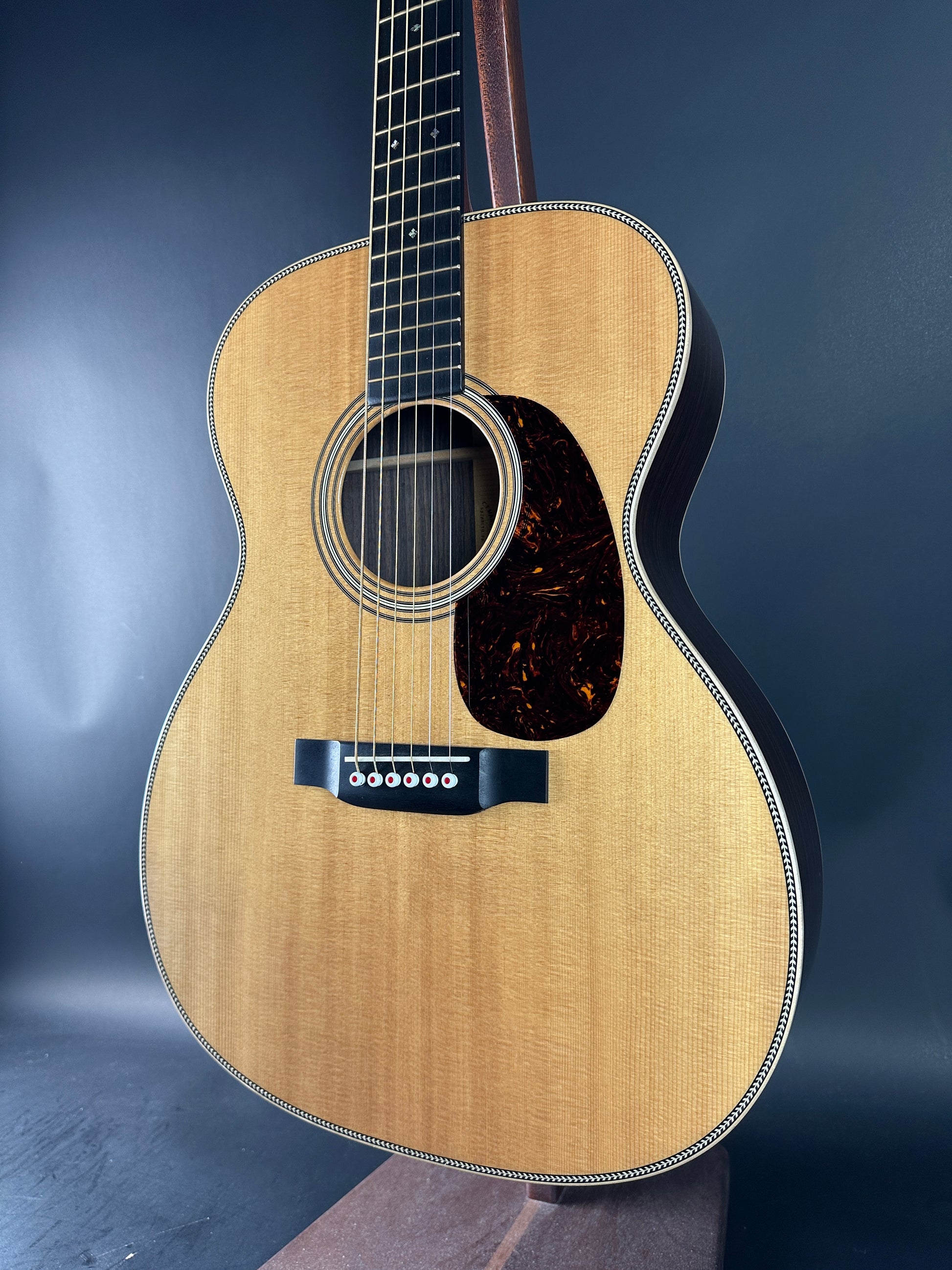 Acoustic guitar with a wooden finish on a dark background