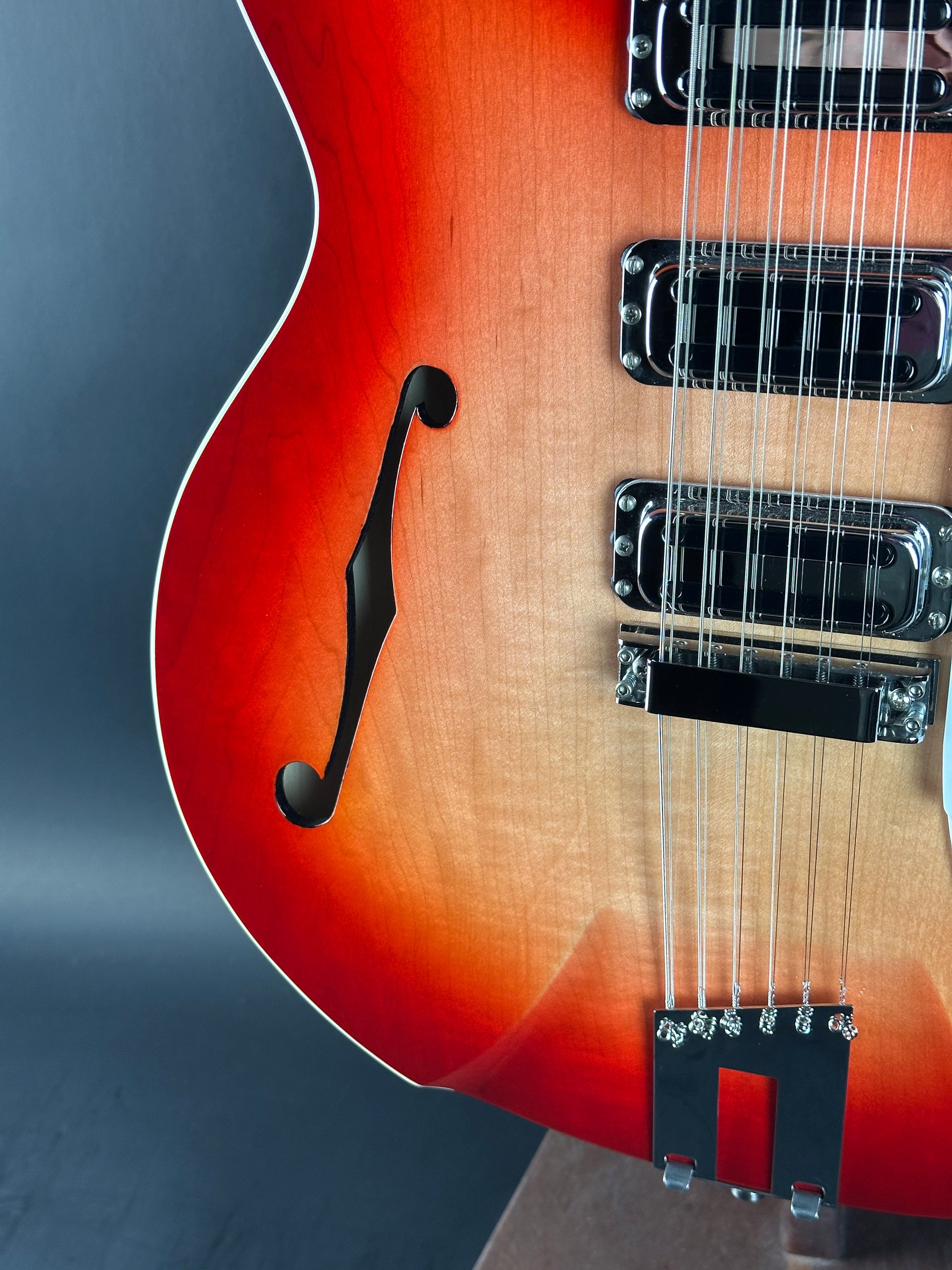Close-up of a sunburst electric guitar on a blue background
