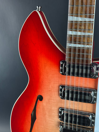 Close-up of a red electric guitar on a dark background