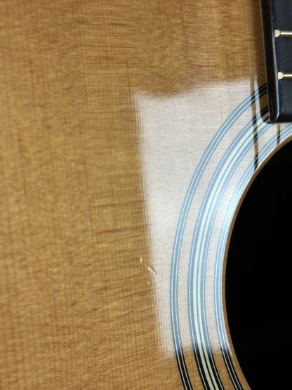 Close-up of an acoustic guitar's soundhole and wooden body