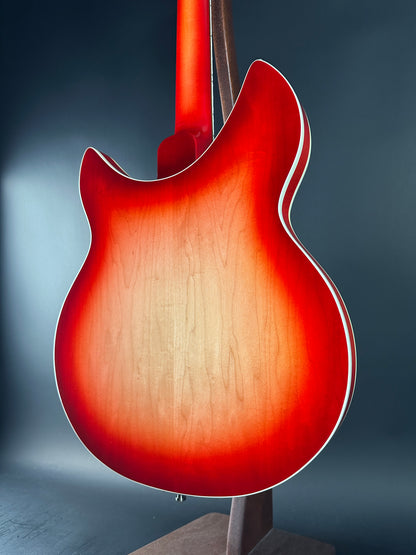 Close-up of a red electric guitar body on a dark background