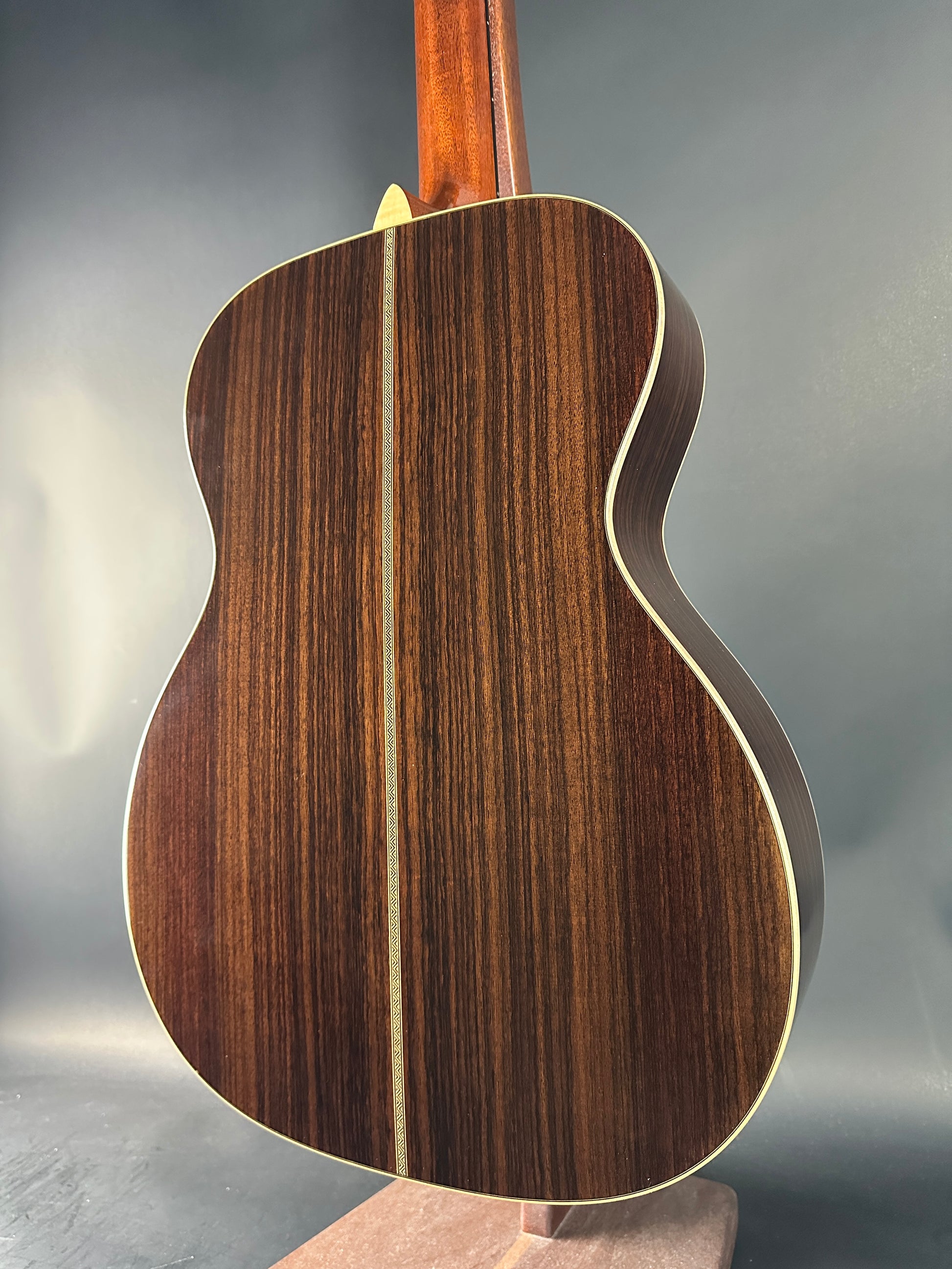 Close-up of a wooden acoustic guitar on a gray background
