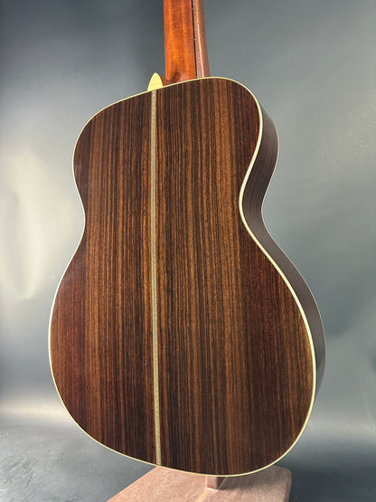 Close-up of a wooden acoustic guitar on a gray background