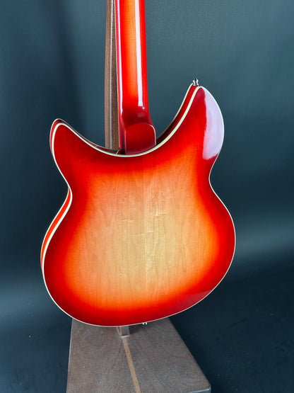 Close-up of a red electric guitar on a dark background