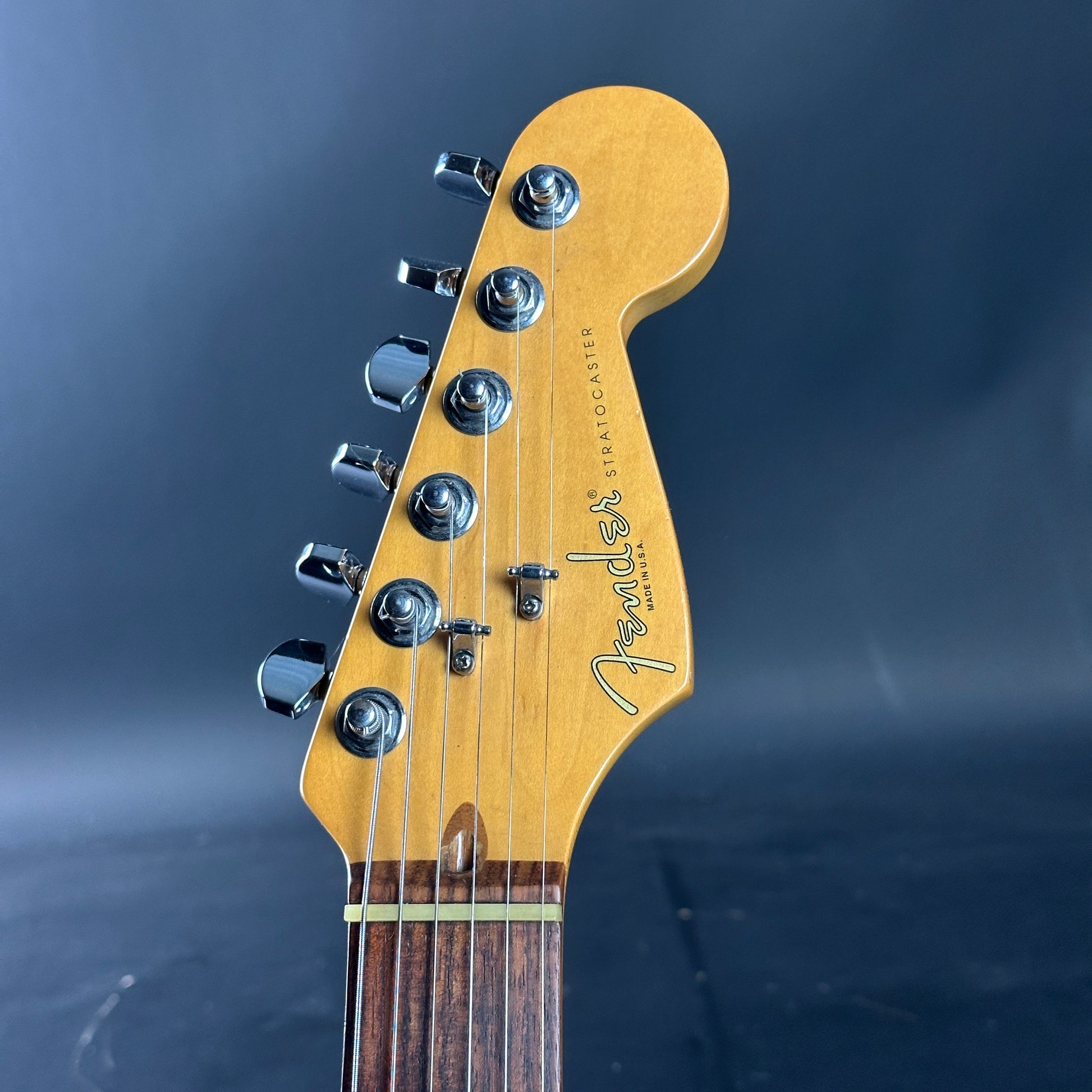 Fender Stratocaster guitar headstock on a dark background