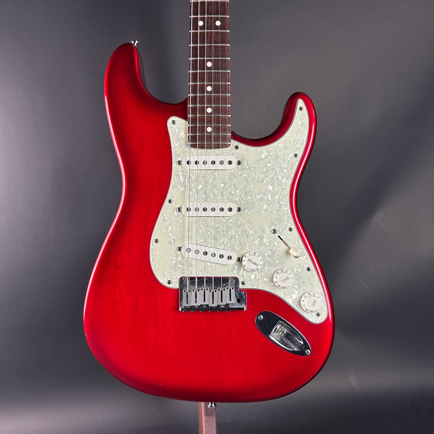 Red electric guitar on a gray background