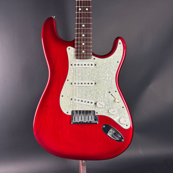 Red electric guitar on a gray background