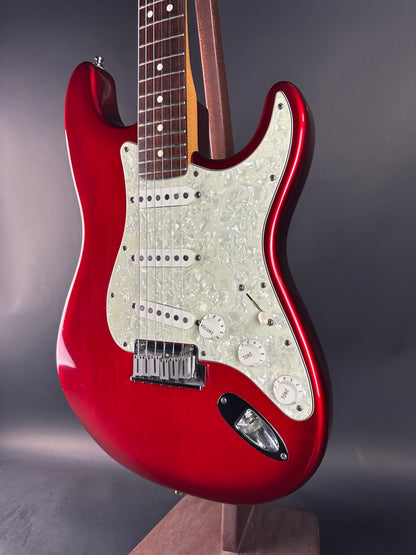 Red electric guitar on a gray background