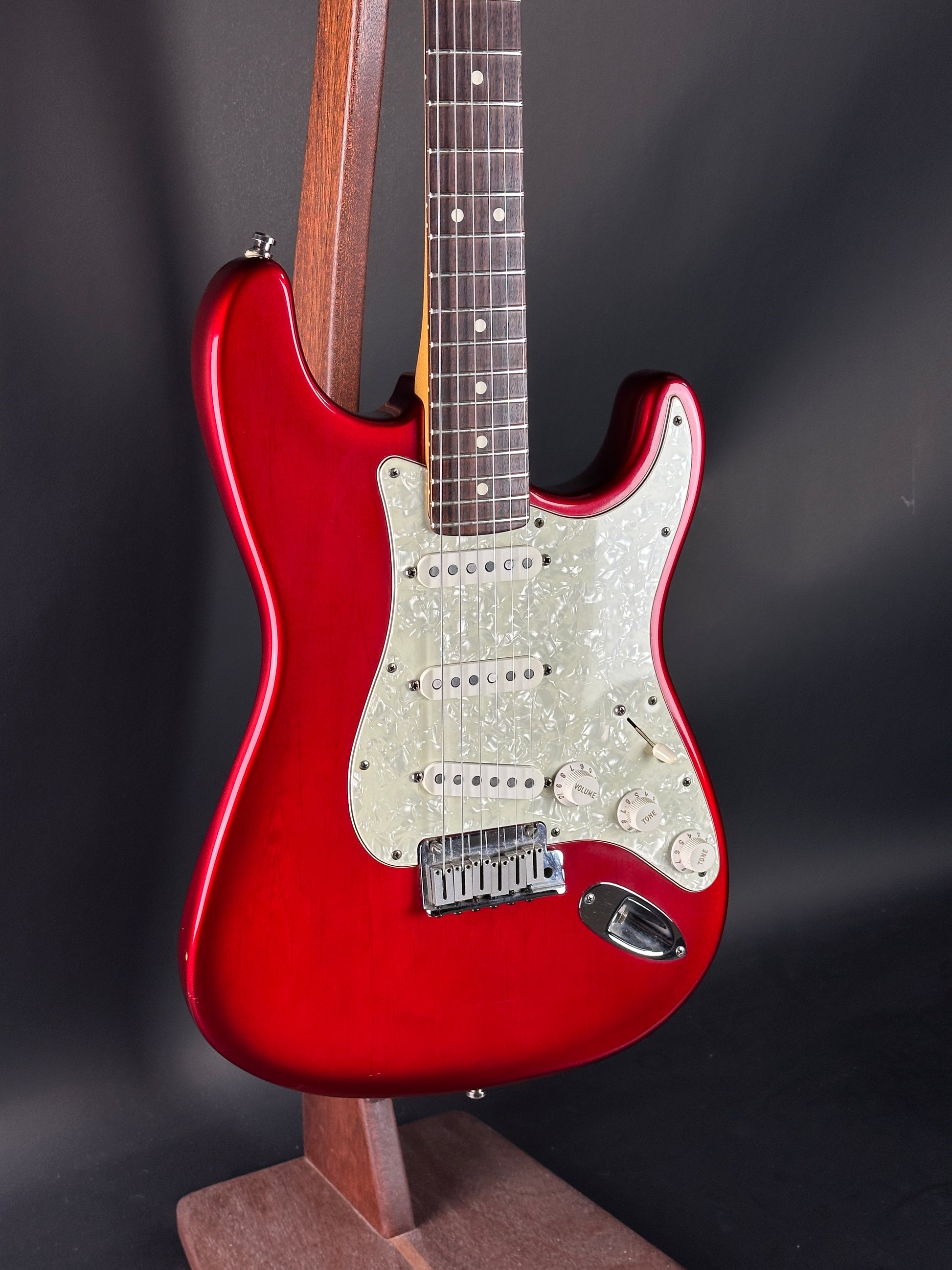 Red electric guitar on a dark background