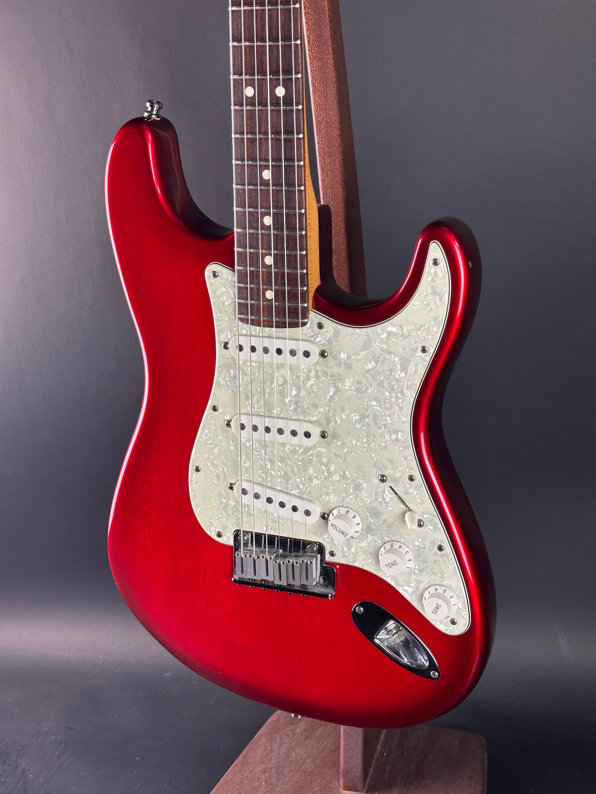 Red electric guitar on a gray background
