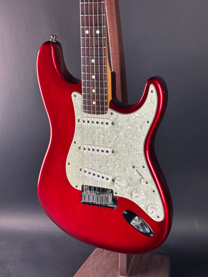 Red electric guitar on a gray background