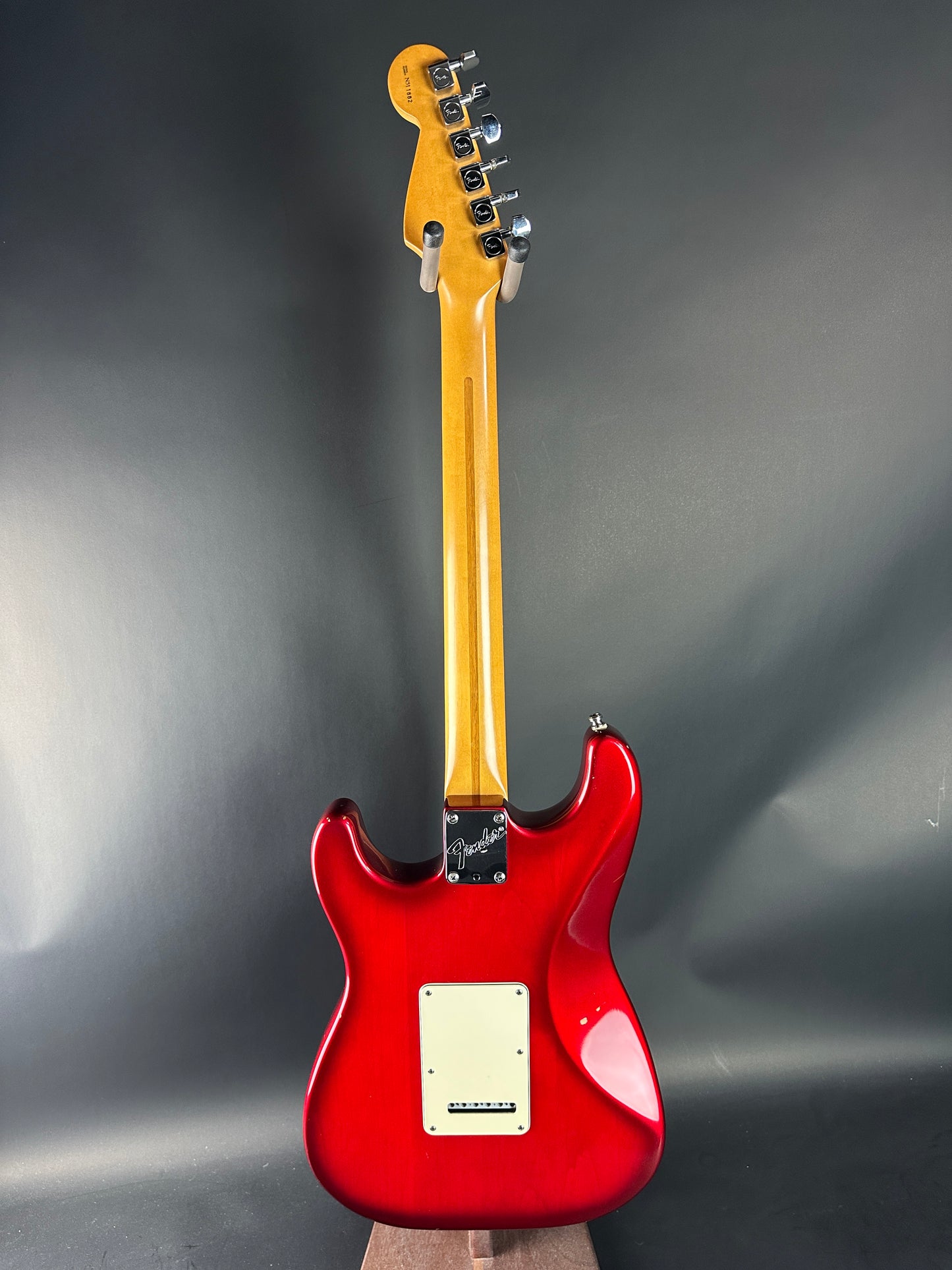 Red electric guitar on a gray background