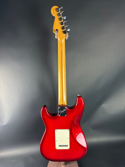 Red electric guitar on a gray background