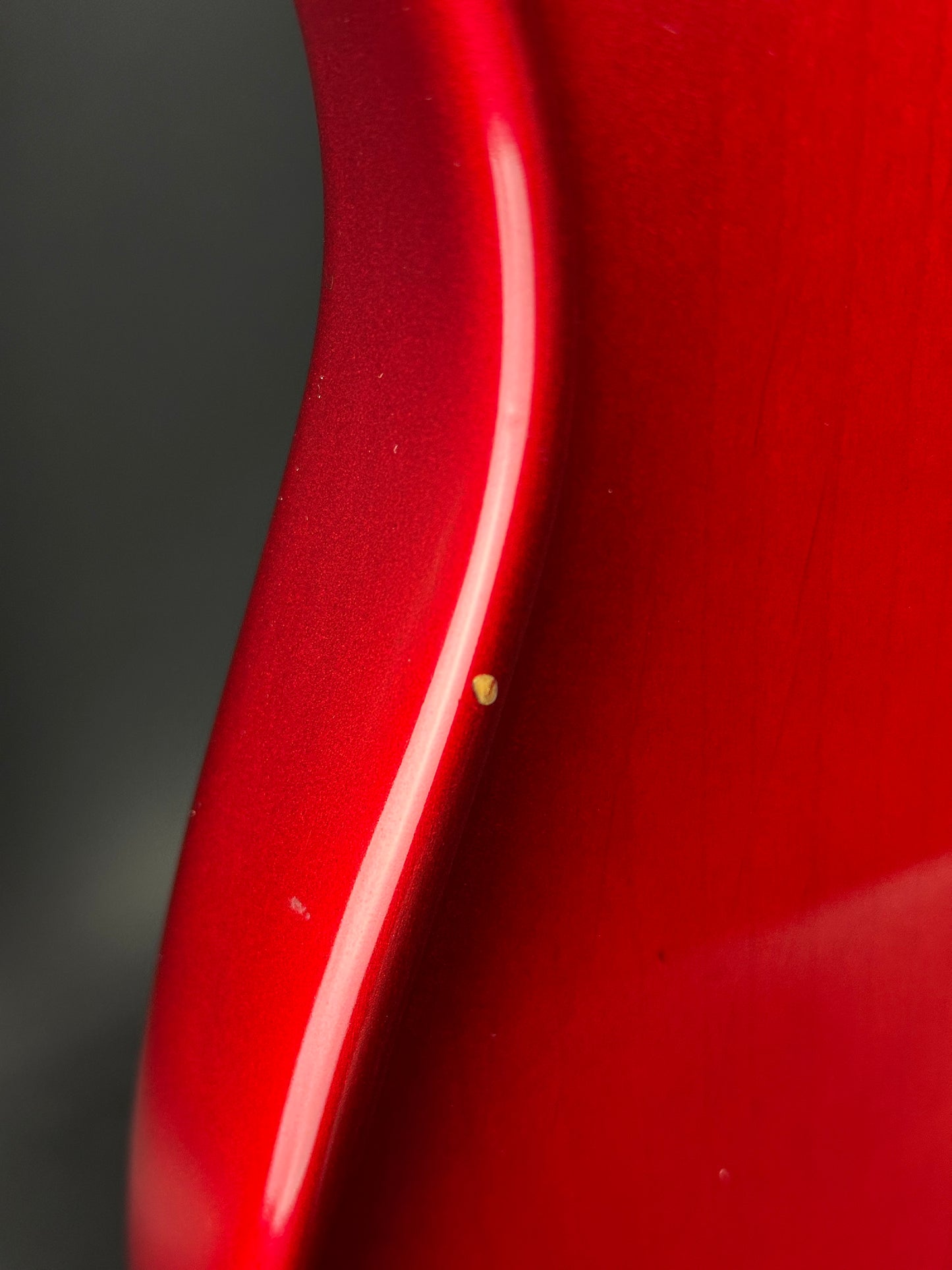 Close-up of a red surface with a small scratch.