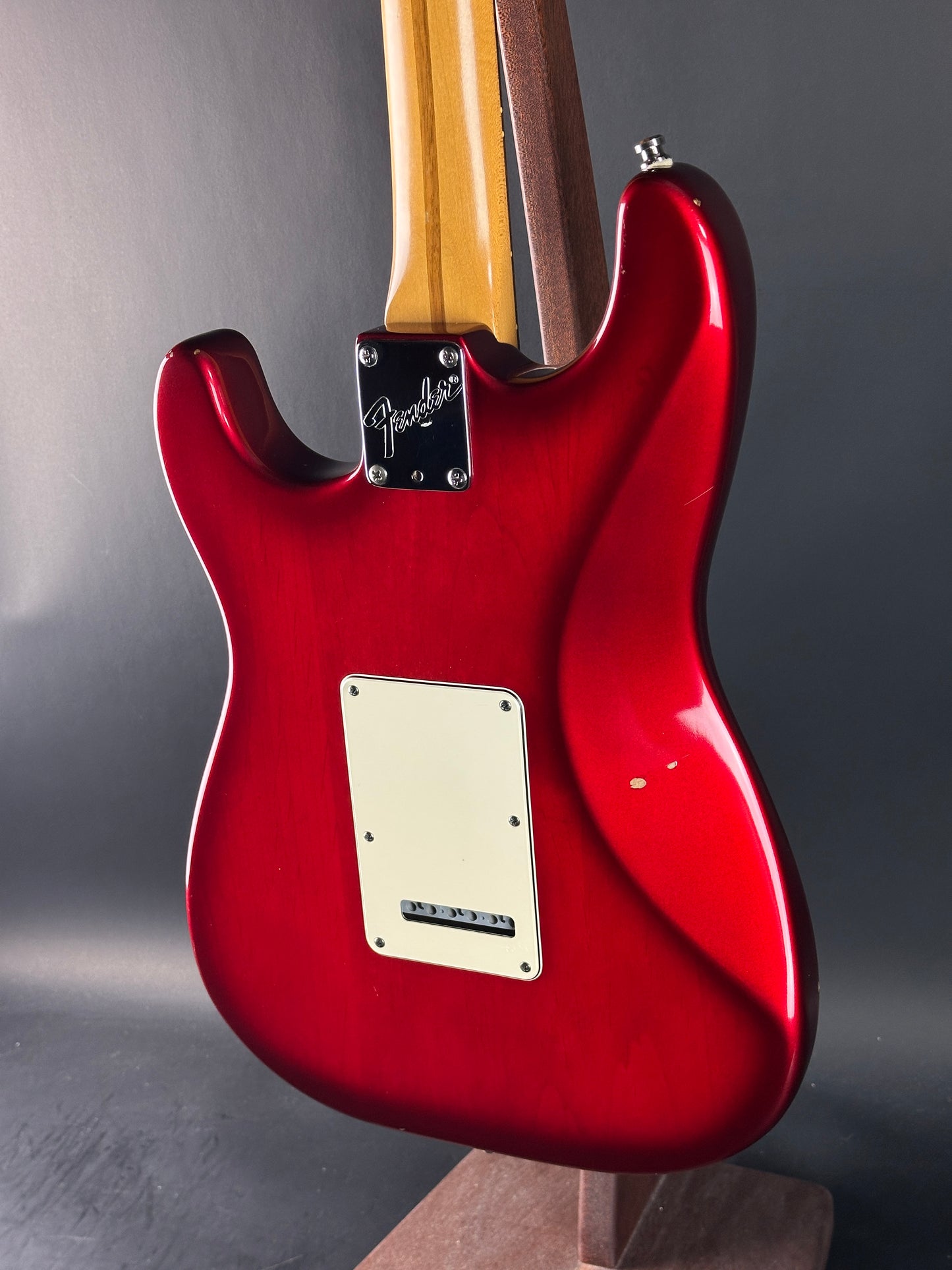 Red electric guitar on a dark background
