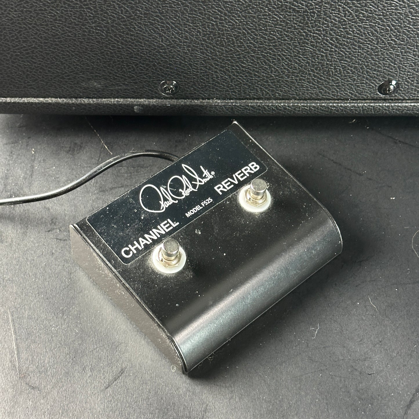 Black footswitch with 'PRS' branding on a gray surface