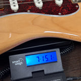 Used Squier 70's Classic Vibe Stratocaster Natural on scale displaying weight.