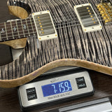 Guitar on a digital scale displaying weight