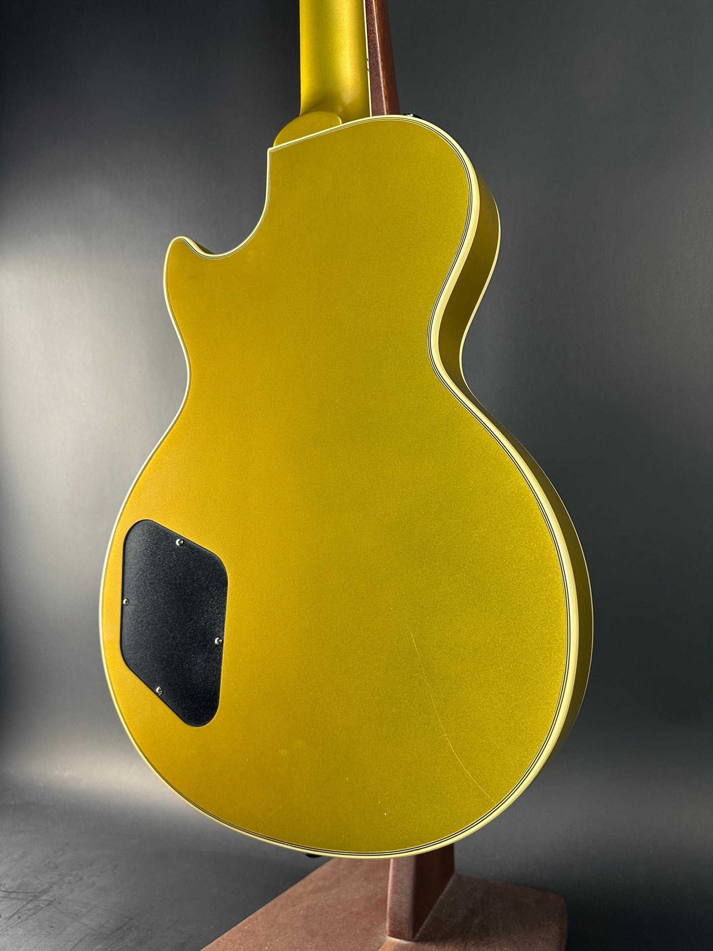 Gold electric guitar on a dark background