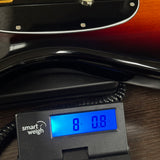 Used Fender American Classic Pro Mustang Bass 3-Color Sunburst on scale displaying weight.
