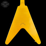 Yellow guitar pickguard with 'Tone Shop' logo in the corner