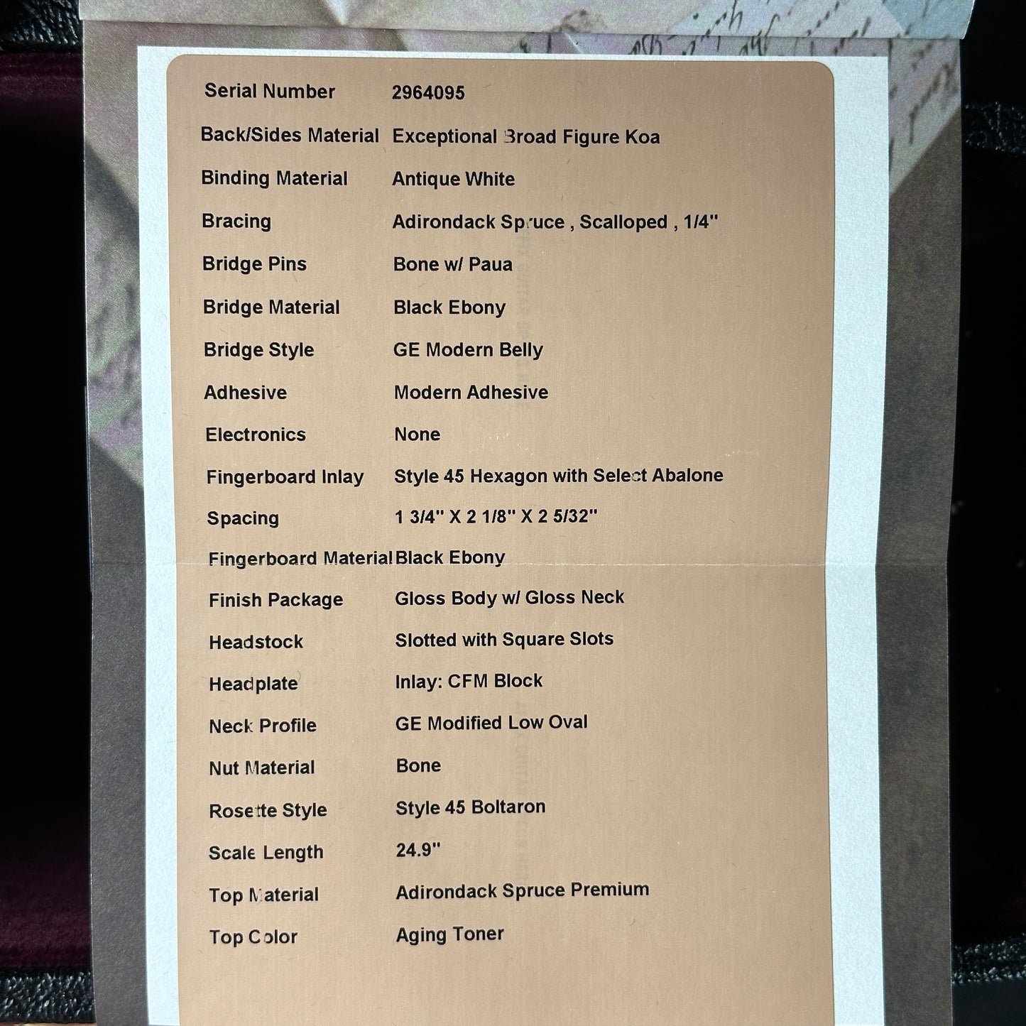 Technical specifications sheet for a guitar on a cardboard background
