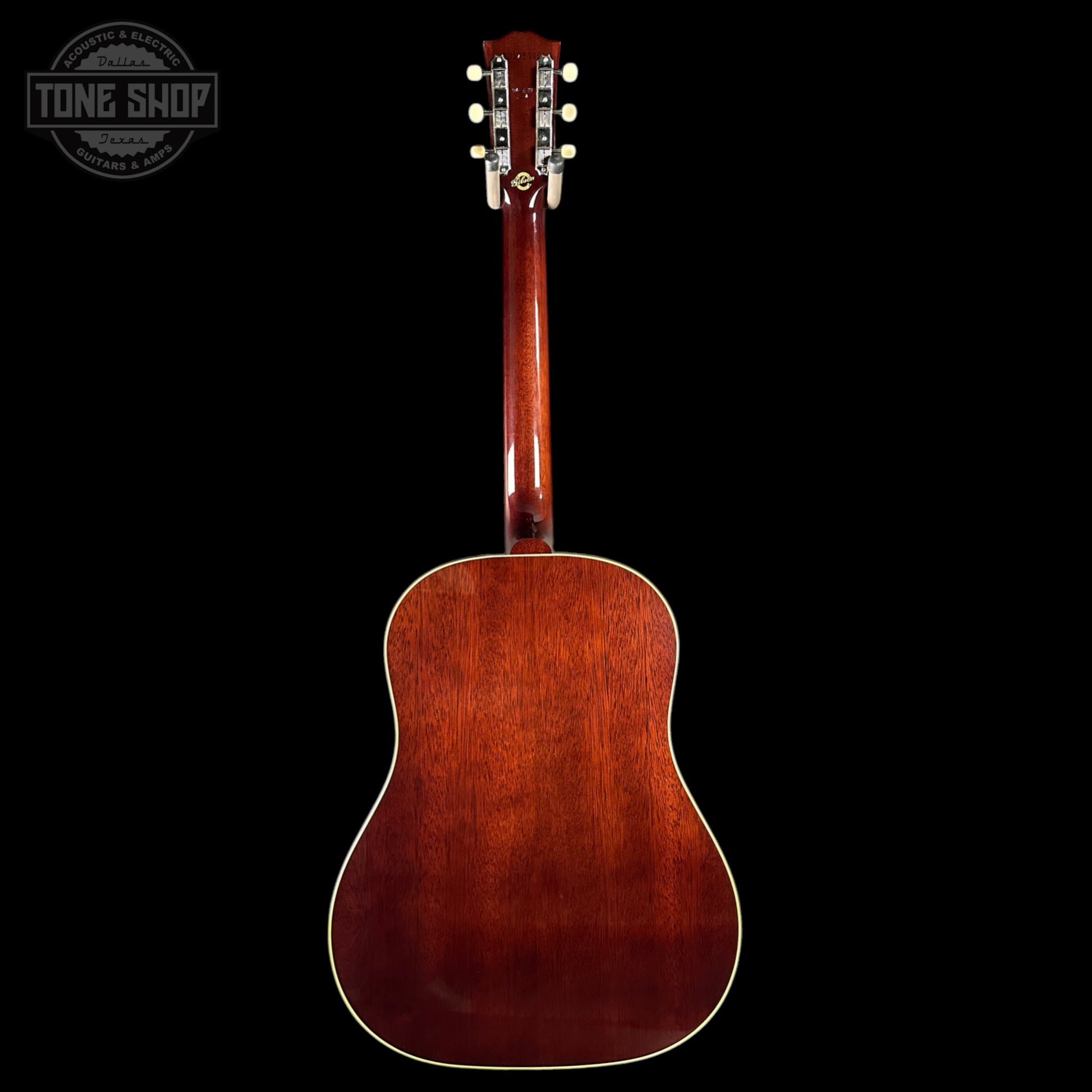 Back view of a wooden acoustic guitar with a dark brown finish on a black background, featuring the Tone Shop logo.