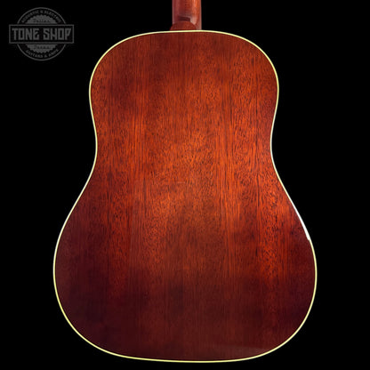 Back view of a wooden acoustic guitar with a dark brown finish on a black background, featuring the Tone Shop logo.