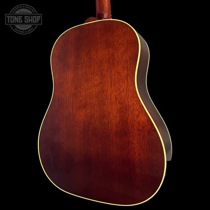 Back view of a wooden acoustic guitar with a dark brown finish on a black background, featuring the Tone Shop logo.