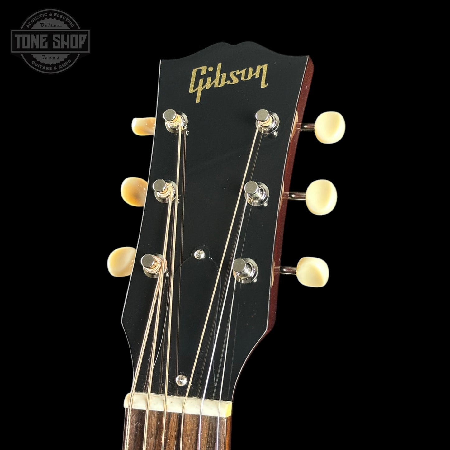 Gibson guitar headstock with brand logo on a black background