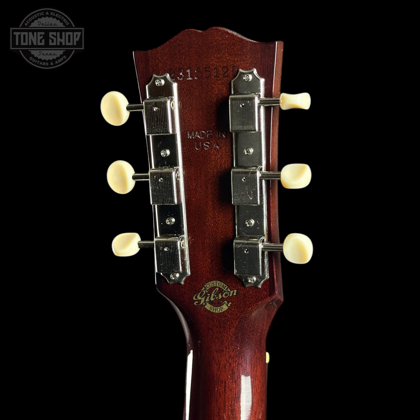 Gibson guitar headstock with brand logo on a black background