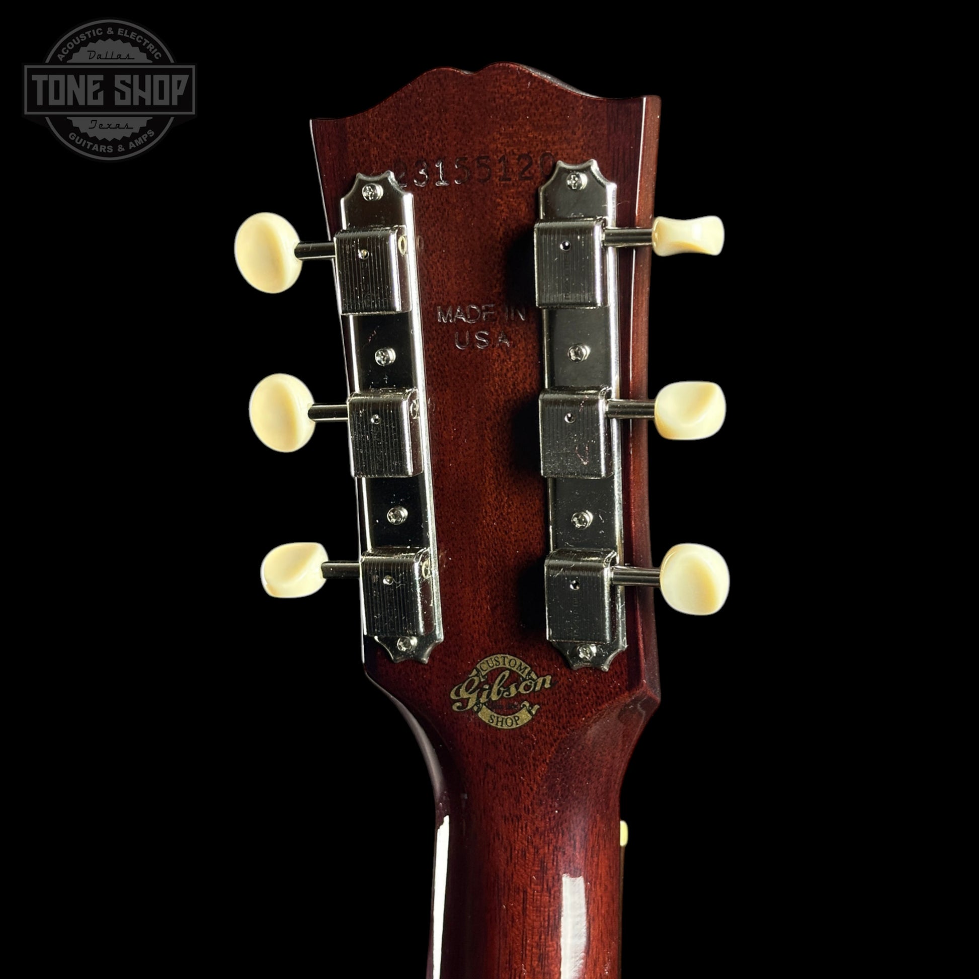 Gibson guitar headstock with brand logo on a black background