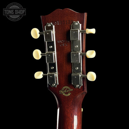 Gibson guitar headstock with brand logo on a black background