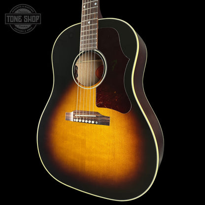 Acoustic guitar with a sunburst finish on a black background, featuring the Tone Shop logo.