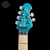 Headstock of Ernie Ball Music Man 30th Anniversary Axis Translucent Blue Quilt.