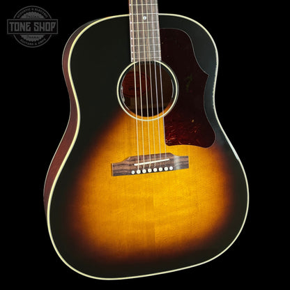 Acoustic guitar with a sunburst finish on a black background, featuring the Tone Shop logo.