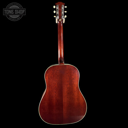 Acoustic guitar with a visible brand logo on a black background